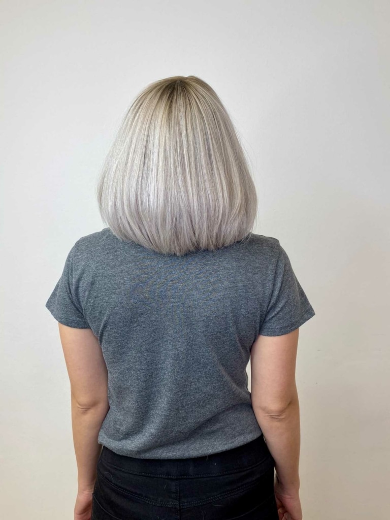 Woman with full silver-grey hair after hair thickening with Hairdreams MicroLines