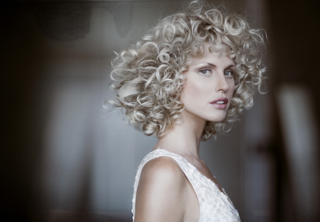 Blonde woman with curls and short hair